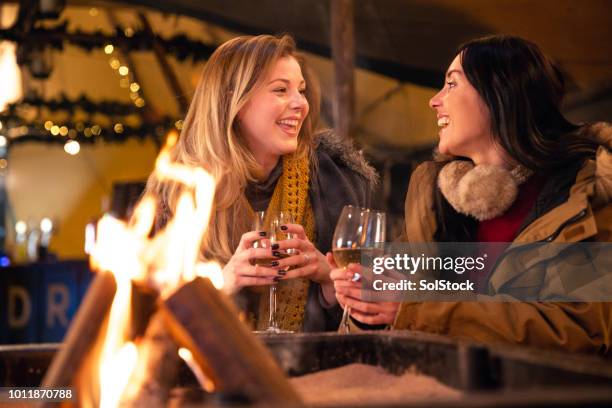 dos amigos riendo juntos - winter fire fotografías e imágenes de stock