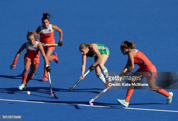 Kathryn Mullan of Ireland passes the ball whilst under pressure from Netherlands players during the FIH Womens Hockey World Cup Final between...