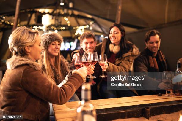 enjoying a glass of wine - christmas market uk stock pictures, royalty-free photos & images