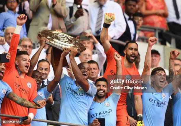 The Manchester City players celebrate as Vincent Kompany and Fernandinho lift the Community Shield trophy after the FA Community Shield match between...