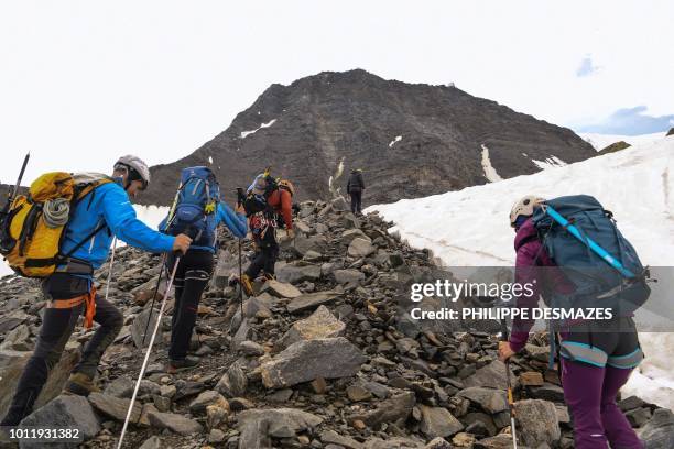 Group of mountaineers takes the 'Couloir du Gouter' on the 'Voie Royale" route to climb atop the Mont-Blanc peak on August 6, 2018 in the Mont-Blanc...