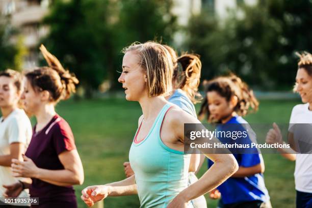 group of women out running together - public park stock pictures, royalty-free photos & images