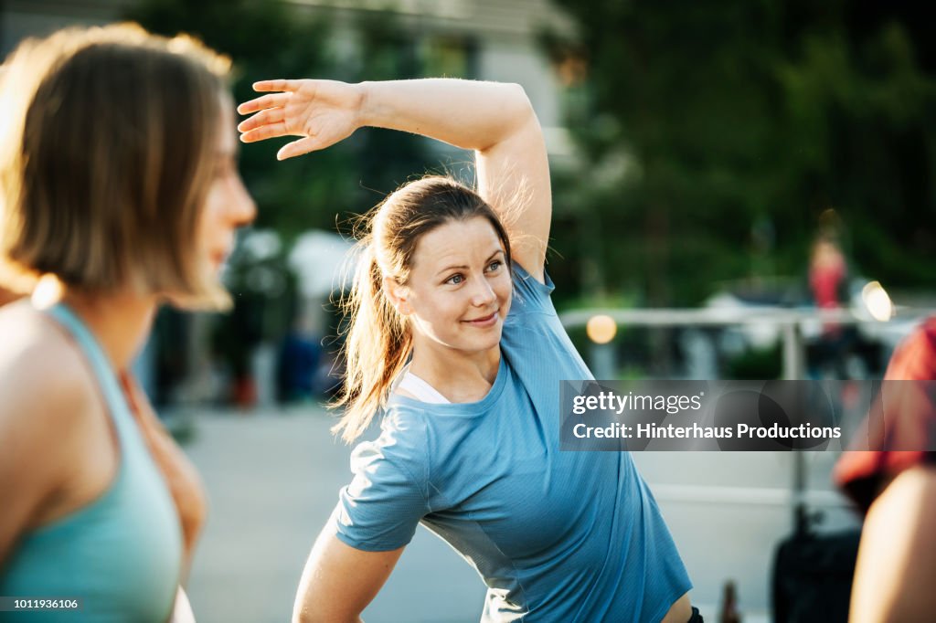 Women Warming Up Outside Together