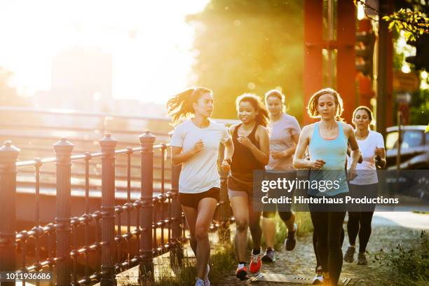 group of women out for evening run together - german indian society stock pictures, royalty-free photos & images