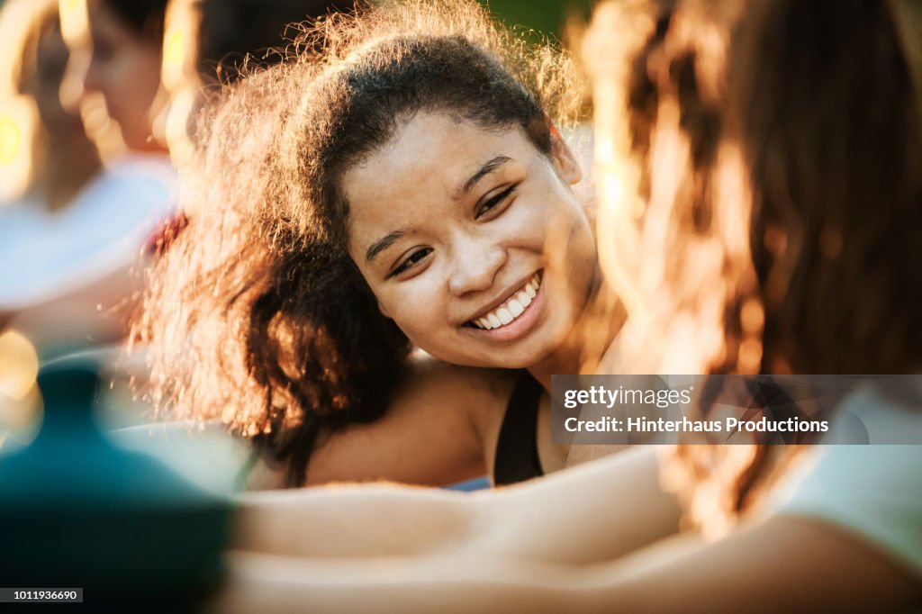 Young Woman Smiling While Out With Fitness Group