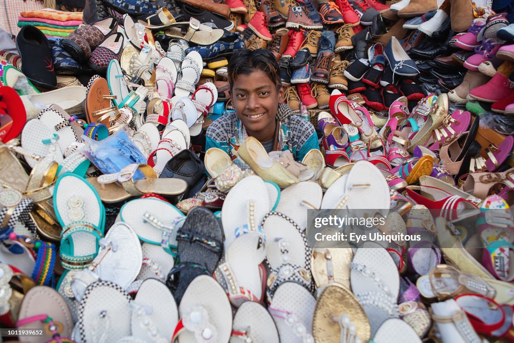 A shoe & sandal vendor in the cotton market in the old city of Delhi.