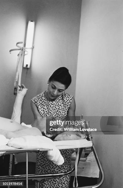 English ballerina Margot Fonteyn pictured nursing her wounded husband Roberto Arias , lying in a hospital bed on 22nd June 1964. Roberto Arias, a...