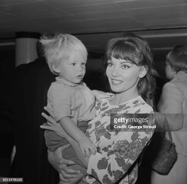 Australian actress Diane Cilento pictured with her son Jason, from her marriage to Sean Connery, at London Airport on 15th June 1964.