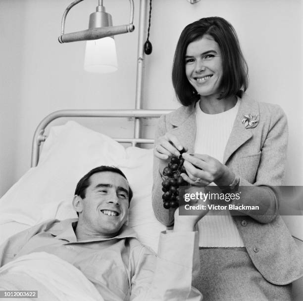 British Formula One racing driver Jackie Stewart with his wife Helen, who is giving him grapes, while undergoing treatment at St Thomas hospital...