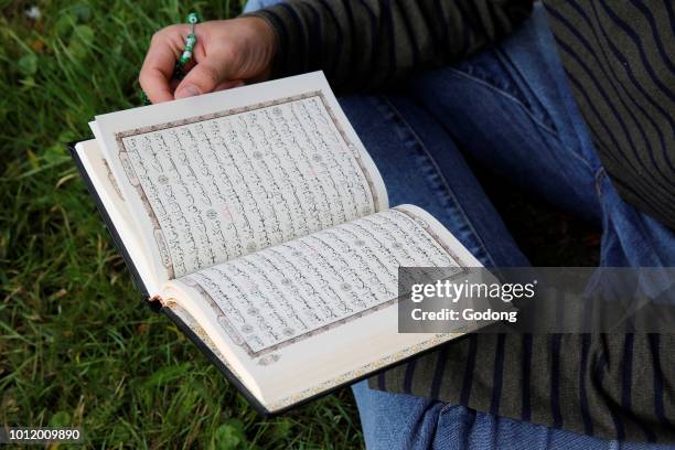 Young man reading the Kuran. France.