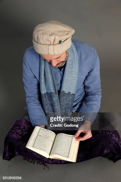 Muslim reading Kuran. Paris, France.