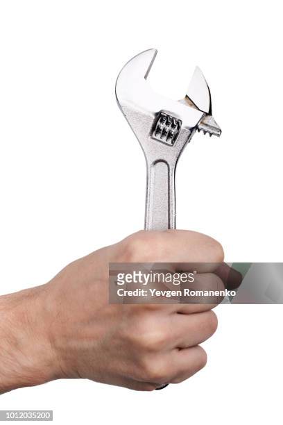 hand holding adjustable wrench, isolated on white background - adjustable wrench stock-fotos und bilder