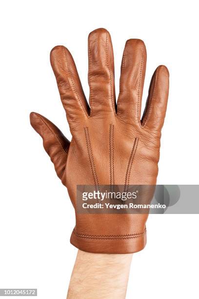 mans hand in brown leather glove - leather glove stock pictures, royalty-free photos & images