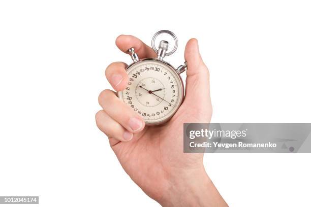 hand with a stopwatch. isolated on white background. - chronomètre photos et images de collection