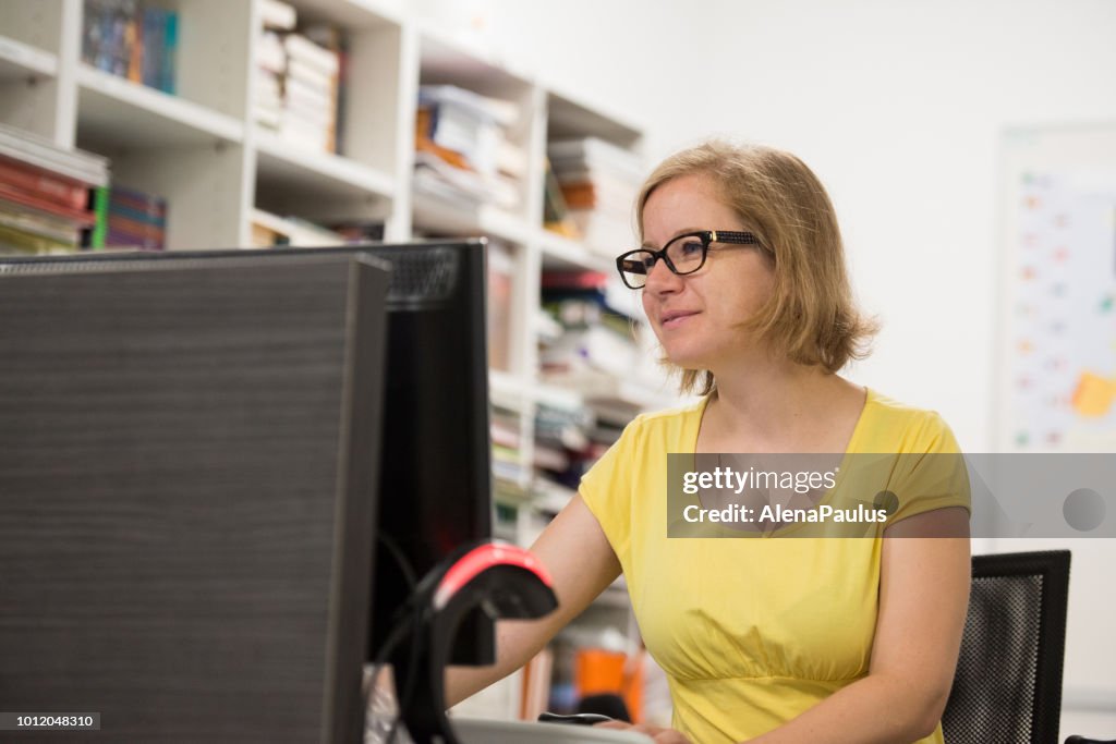 Librarian Using Computer Librarian Working With A Computer Book Rental Desk High-Res Stock Photo ...