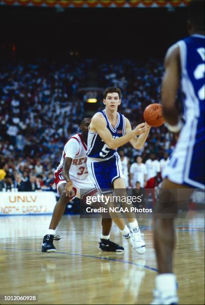 Billy McCaffrey of the Duke Blue Devils passes the ball to a teammate as they take on the UNLV Runnin' Rebels during the semifinals of the NCAA...