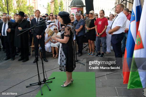 Slovenian actress Polona Vetrih and Robert Waltl of the Jewish Cultural Centre Ljubljanan take part in the ceremony of the Stumbling Stones on August...