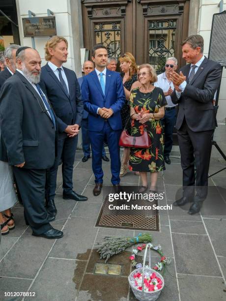 Slovenia Parliament Speaker Matej Tonin , Auschwitz survivor Erika Furst and President of the Republic of Slovenia Borut Pahor stand in front of the...