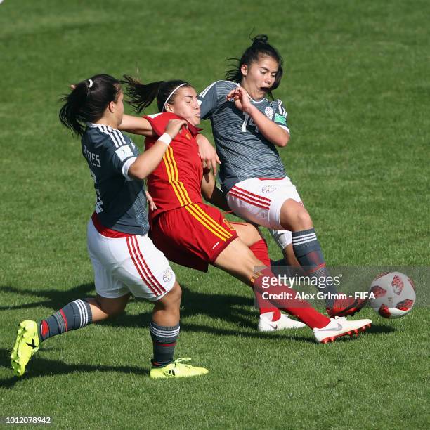 Patricia Guijarro of Spain is challenged by Limpia Fretes and Natalia Villasanti of Paraguay during the FIFA U-20 Women's World Cup France 2018 group...