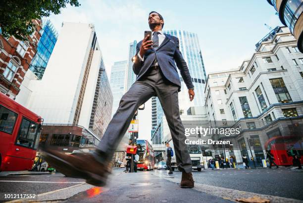 businessman in england crossing the street in the afternoon - wide angle stock pictures, royalty-free photos & images