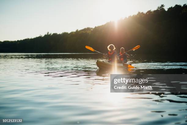 mature couple canoeing at a lake. - カヌー ストックフォトと画像
