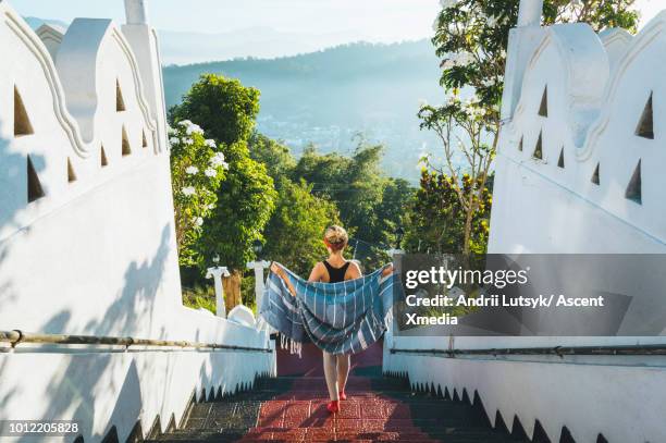 young woman explores buddhist temple grounds - cultura cingalesa imagens e fotografias de stock