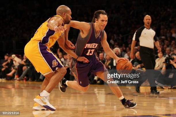 Steve Nash of the Phoenix Suns drives with the ball on Derek Fisher of the Los Angeles Lakers in the third quarter of Game Five of the Western...