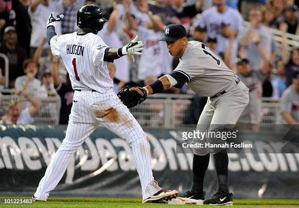 Orlando Hudson of the Minnesota Twins slides into third base safely as Alex Rodriguez of the New York Yankees applies the tag in the fifth inning...