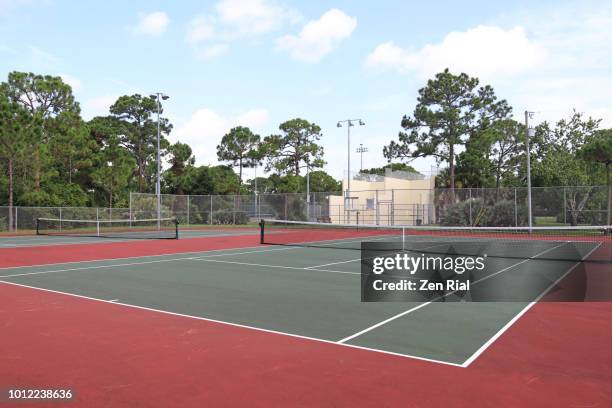 empty tennis court and racquetball courts in a tropical setting - hardcourt stock pictures, royalty-free photos & images