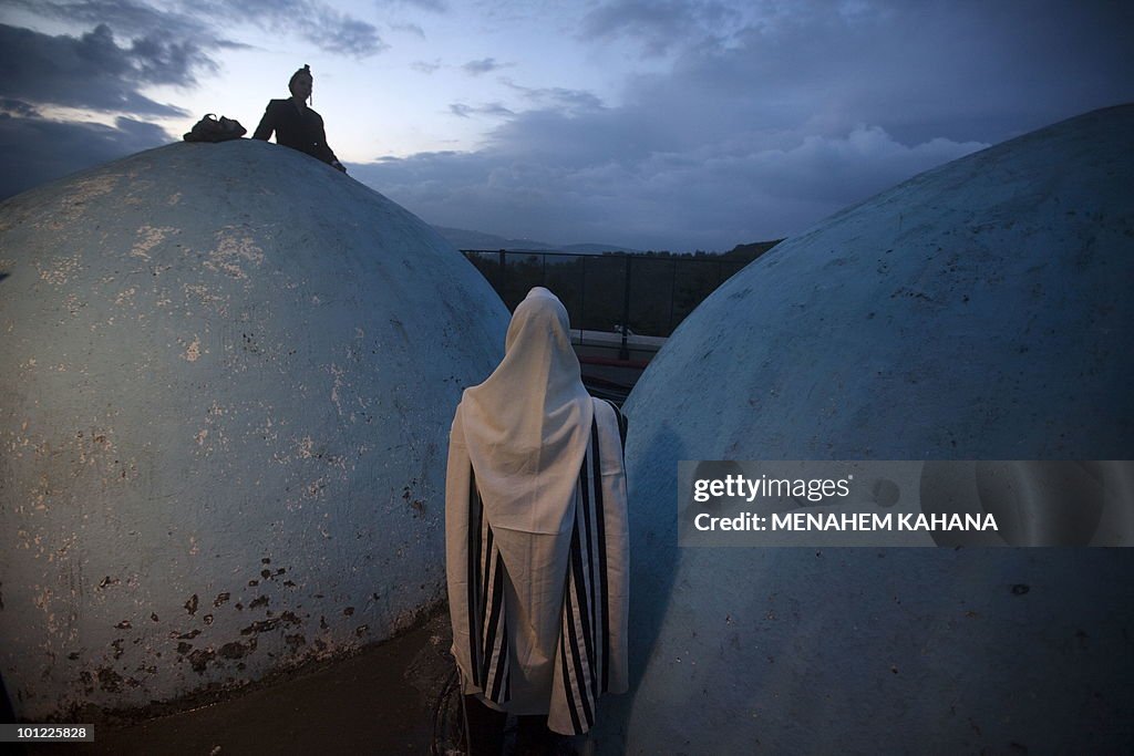 Ultra Orthodox Jews pray at the grave si