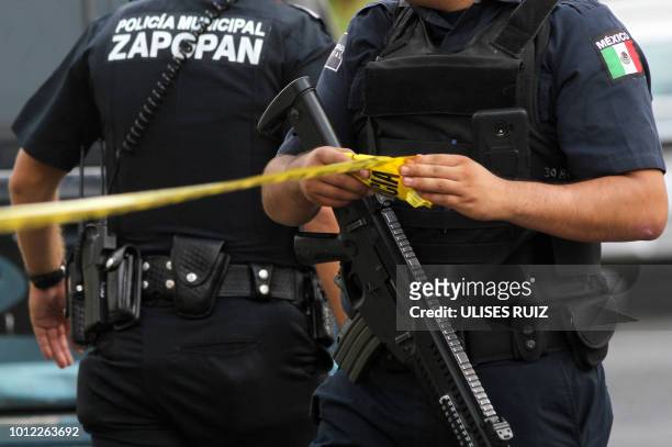 Municipal policemen work in a crime scene after a 40-year man was shot dead in Zapopan, state of Jalisco, Mexico on July 31, 2018. Mexican...