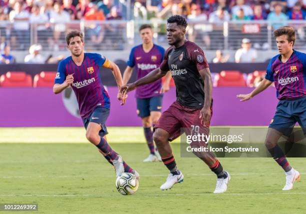 Franck Kessie Midfielder, AC Milan moves between defenders during the International Champions Cup match between AC Milan and FC Barcelona on...