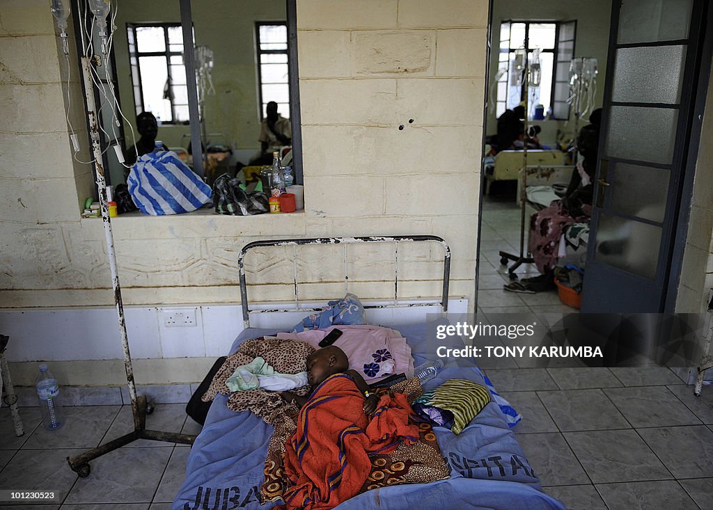 A baby with malaria lays in bed in a mal