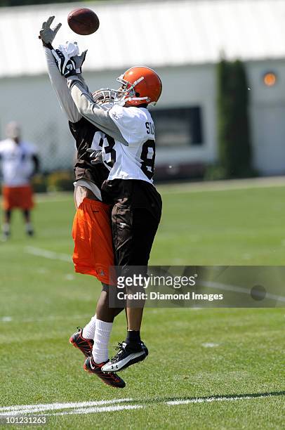 Defensive back Coye Francies and wide receiver Chansi Stuckey of the Cleveland Browns battle for a pass during the team's organized team activity on...