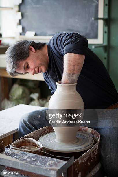 potter throwing clay on pottery wheel. - potter's wheel stock pictures, royalty-free photos & images