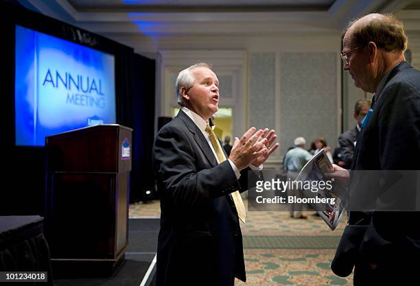 Robert Niblock, chief executive officer of Lowe's Cos., left, speaks with shareholder Harold Eage during the company's annual meeting in Charlotte,...