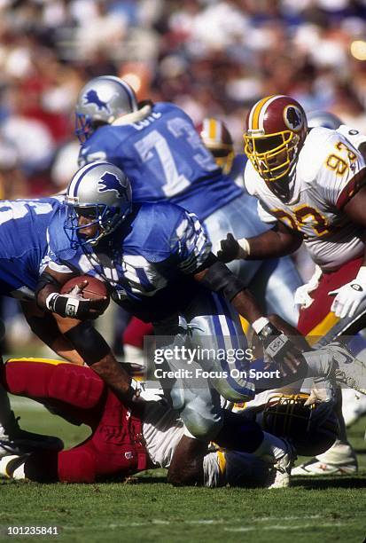 S: Barry Sanders of the Detroit Lions carries the ball against the Washington Redskins circa early 1990's during an NFL football game at RFK Stadium...