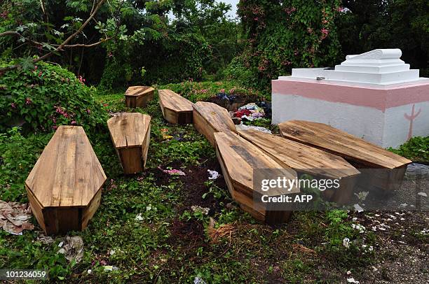 Caskets of victims of the violence in Kingston are left in the May Pen Cemetery of the Jamaican capital on May 28, 2010. Jamaican police and soldiers...