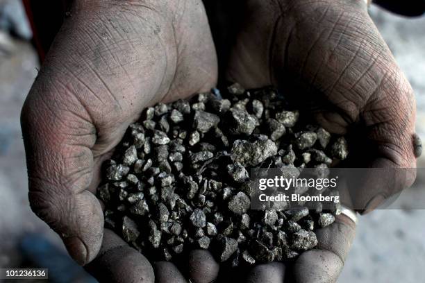 Cooperative miner displays silver deposits from the Candelaria mine where tin, zinc, and silver are extracted in the Cerro Rico above Potosi,...