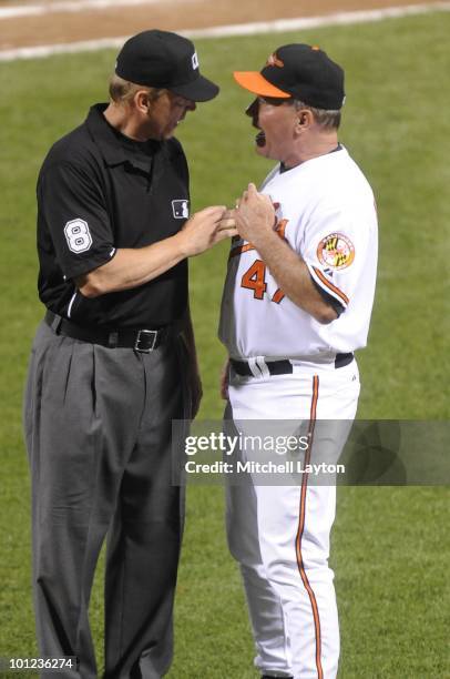Dave Trembley, manager of the Baltimore Orioles, dicusses play umpire Jeff Kellogg during a baseball game against the Oakland Athletics on May 26,...