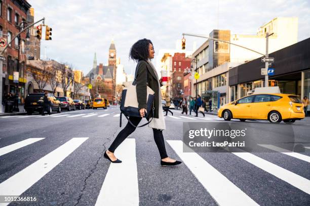 successful and elegant woman walks the streets of new york - businesswoman nyc stock pictures, royalty-free photos & images