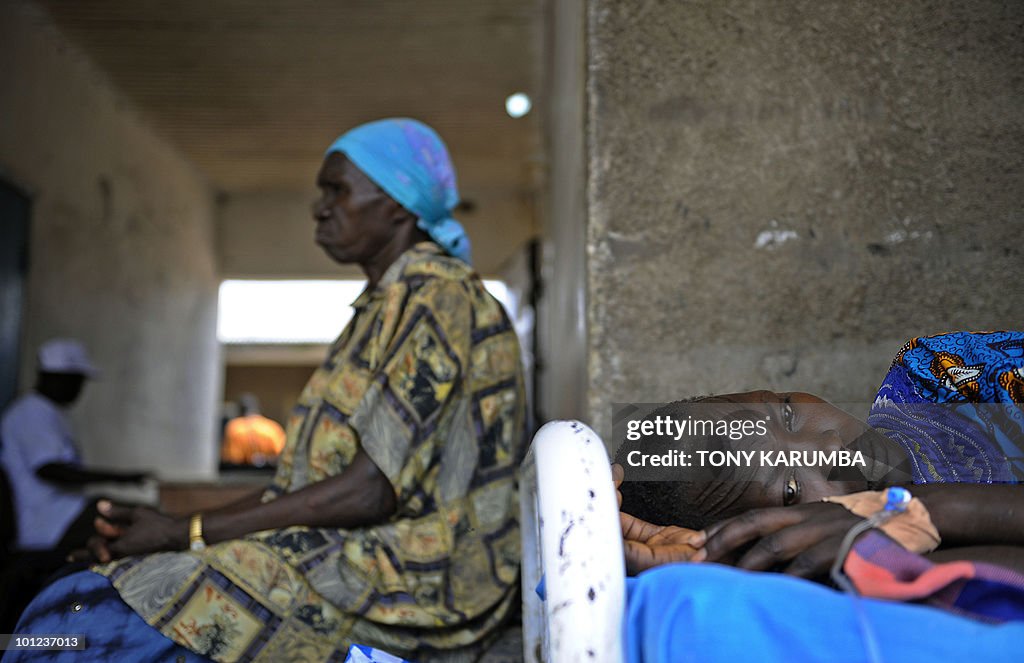 A south Sudanese woman lays on a bed on