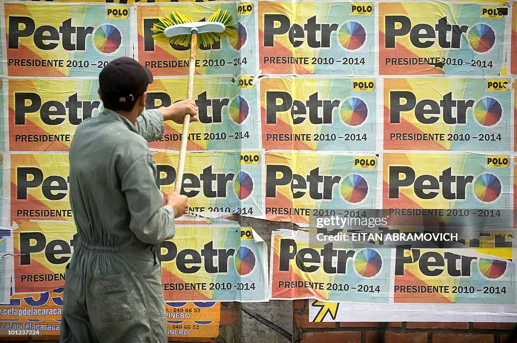 A man removes from a wall propaganda pos