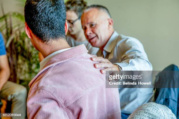 males involved in emotional conversations and scenarios - wellbeing support stock pictures, royalty-free photos & images