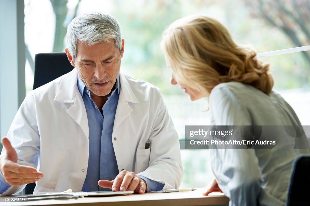 Doctor consulting patient in clinic