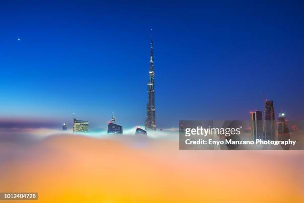 burj khalifa submerge in fog - dubai fog stock pictures, royalty-free photos & images