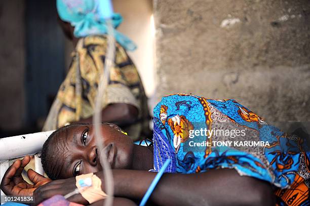 South Sudanese woman lays in bed on April 2 at a health clinic in Terekeka, 82 km north of Juba, an area where the population is exposed to malaria,...