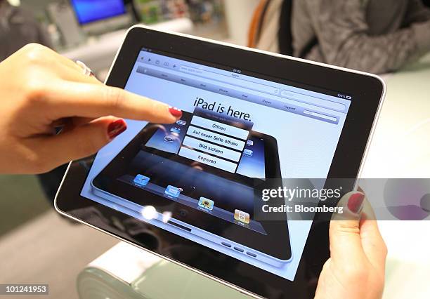 An employee uses an Apple Inc. IPad tablet computer at the Gravis computer shop in Frankfurt, Germany, on Friday, May 28, 2010. Following the sale of...