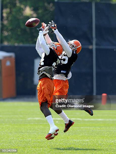 Defensive backs Eric Wright and Coye Francies of the Cleveland Browns battle for a pass during the team's organized team activity on May 27, 2010 at...