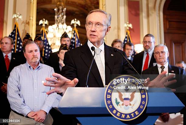 Senate Majority Leader Sen. Harry Reid speaks as Al Snyder of Maryland listens during a news conference to call on the Supreme Court for...